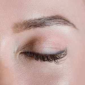 Close-up view of closed female eyes with long eyelashes